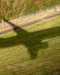 The shadow of a commercial jet as it comes in to land at Edinburgh Airport, Scotland.