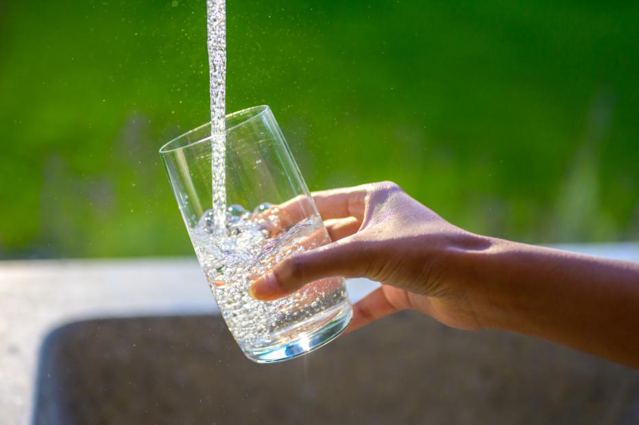 Filling glass with fresh water from tap
