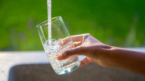 Filling glass with fresh water from tap