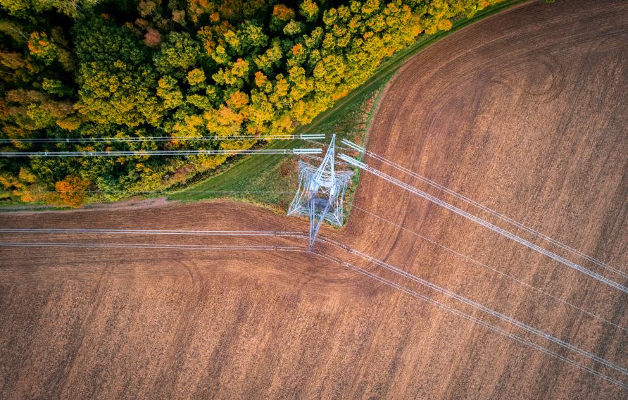 Aerial view of electricity pylon in field