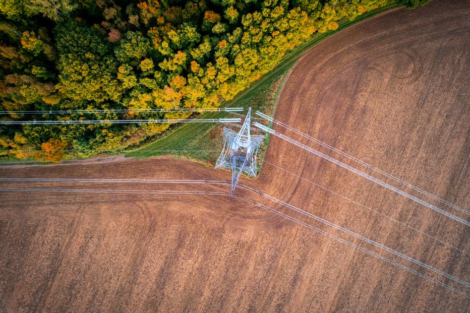 Aerial view of electricity pylon in field