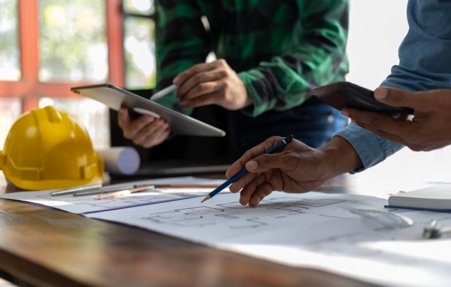 Construction and structure concept planning of Engineer or architect meeting for project working with partner and engineering on model building and blueprint in working site. stock photo