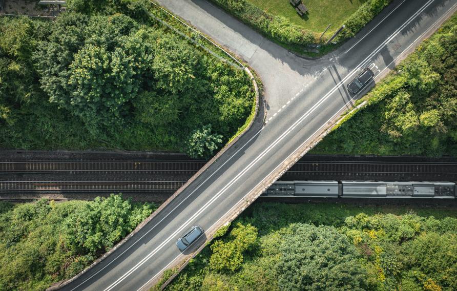 Aerial view of road bridge crossing a train line